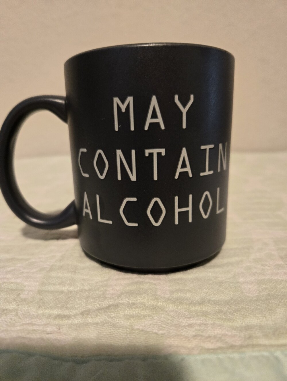 TYPO "May Contain Alcohol" Black Coffee Mug.